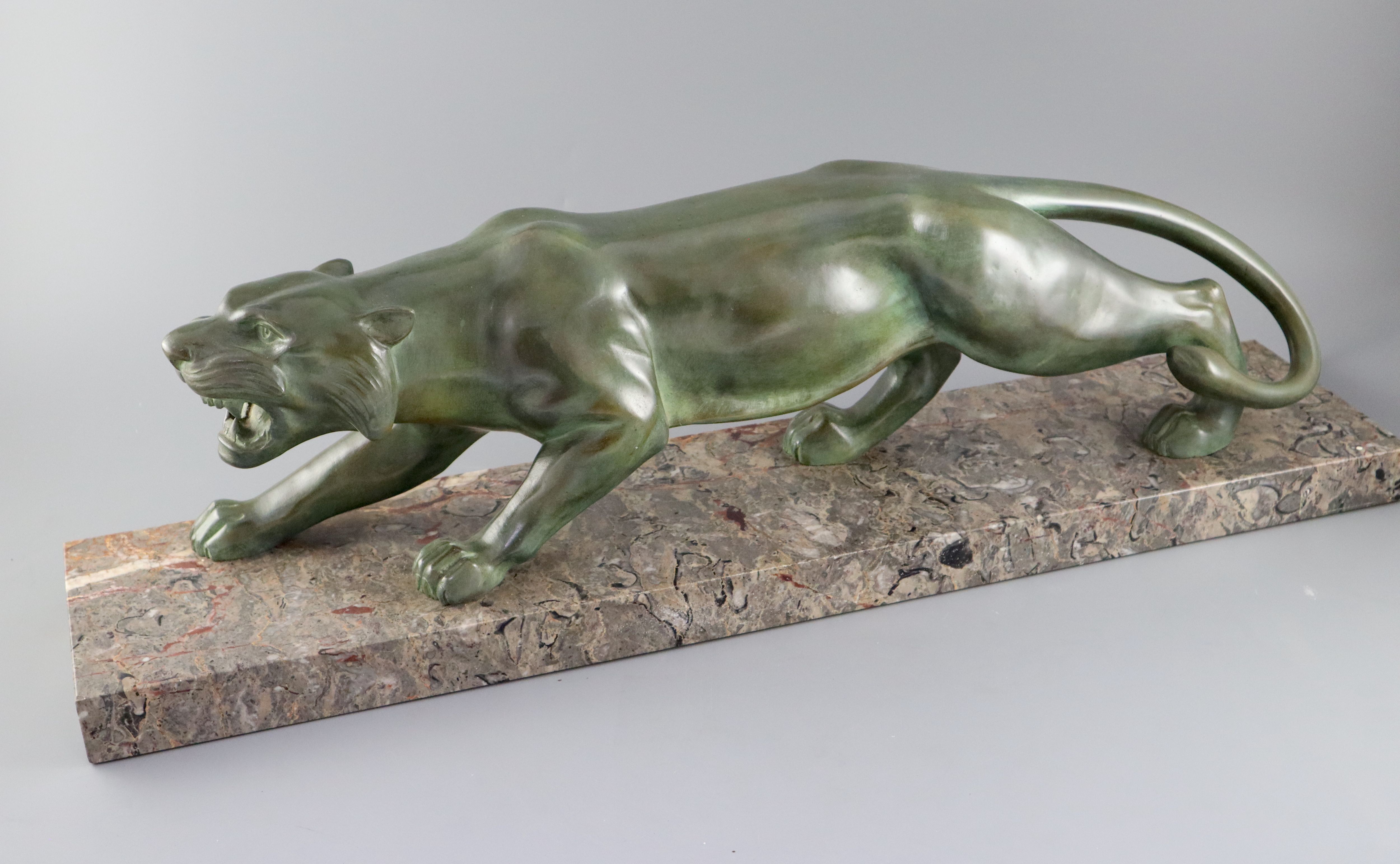 Brault. An Art Deco patinated bronze model of a prowling panther, width 29.5in. height 8.5in.